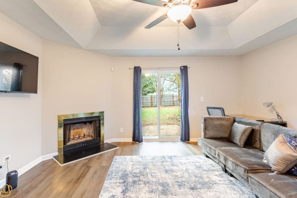 Living room at Whispering Oaks with a fireplace and sliding doors to the backyard.