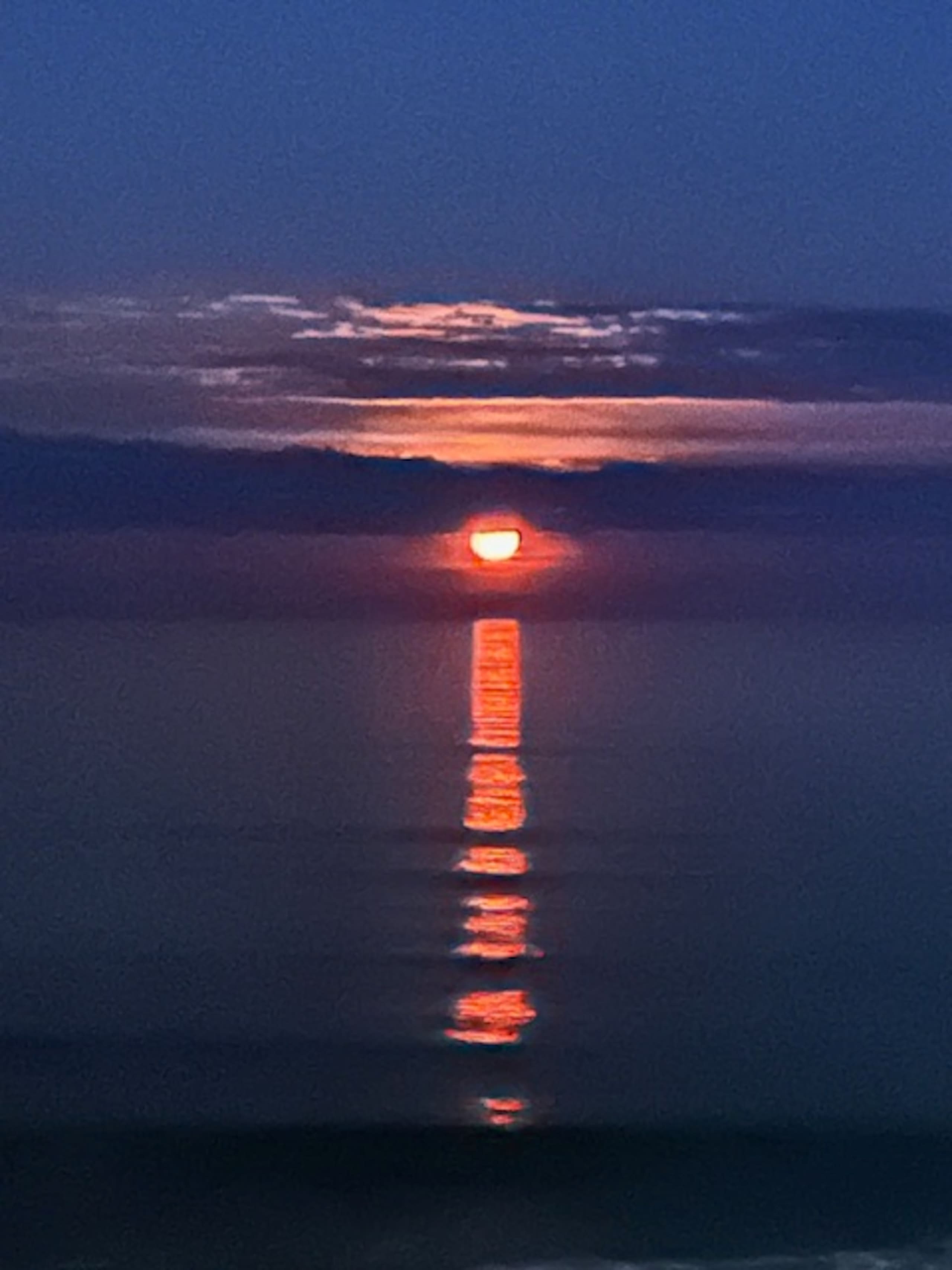 Moonset reflecting on the ocean at dusk