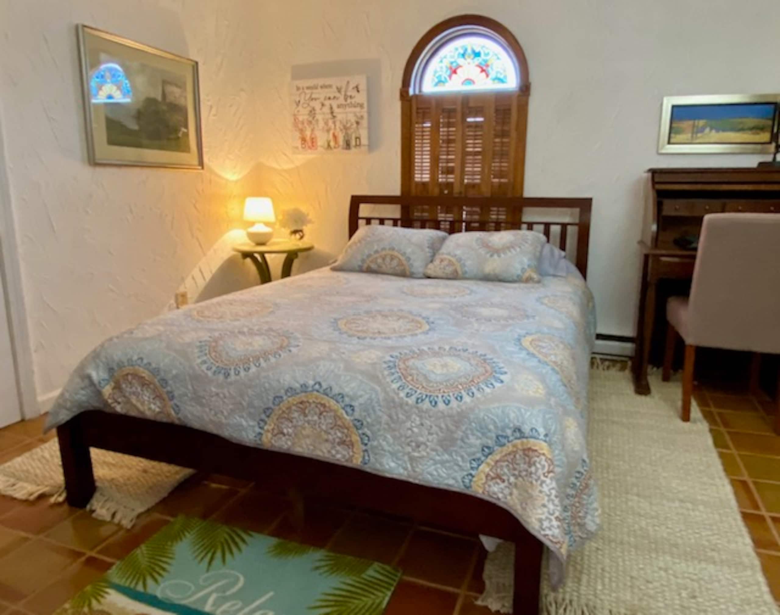 Second bedroom with queen bed and arched window